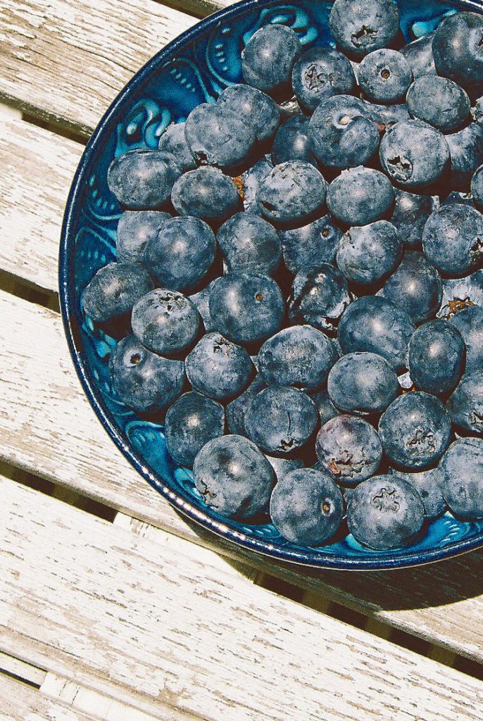 A close up picture of blueberries in a bowl.